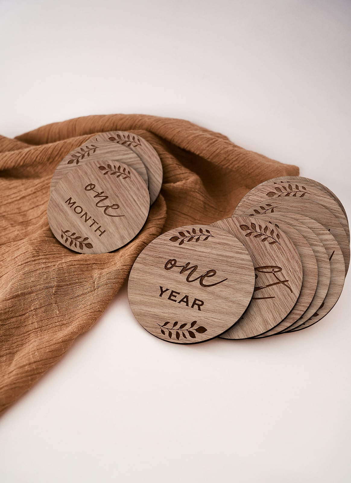 Another image of a laser cutting and engraving project with a brown cloth using Auckland plywood supplier Plyco's 3mm American Walnut Legnoply Pack on a white background